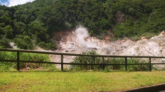 Steaming geothermal vents rise from the earth at Saint Lucia's Soufri&egrave;re Drive-In Volcano, surrounded by lush jungle and the natural wonder of the Sulphur Springs.