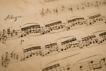 Fototapeta premium Classical music manuscript with flowing notes on aged paper.