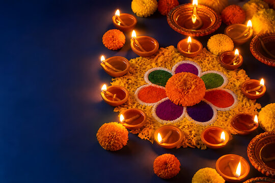 Glowing Diwali oil lamps surrounding a colorful floral rangoli