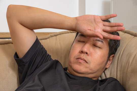 Depression and burnout concept showing a tired man resting with emotional stress and exhaustion for mental health healthcare therapy and psychological support.