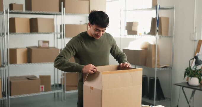 Man, logistics and blade with unboxing for small business, distribution or supply chain for order. Flare, happy supplier or inspection with restock, return or parcel for delivery or courier service