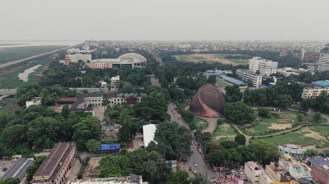 Aerial drone view of Golghar, a massive dome-shaped historic granary in Patna, Bihar, India. The iconic 18th-century monument is surrounded by lush greenery and the urban landscape of Patna
