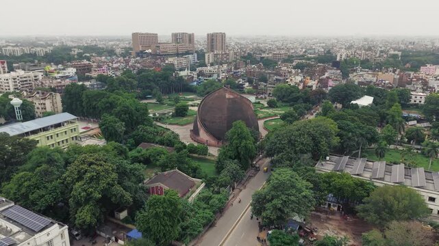 Aerial drone view of Golghar, a massive dome-shaped historic granary in Patna, Bihar, India. The iconic 18th-century monument is surrounded by lush greenery and the urban landscape of Patna