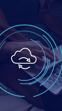 Animation of cloud icon over hands using laptop in office