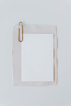 Minimalist Stationery Mockup Featuring Blank Invitation And Brass Paperclip
