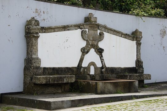 Ornate stone fountain with decorative elements and basin. Portugal - Norte
