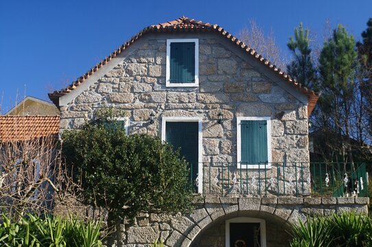 Traditional Portuguese stone house with green shutters. Portugal - Norte