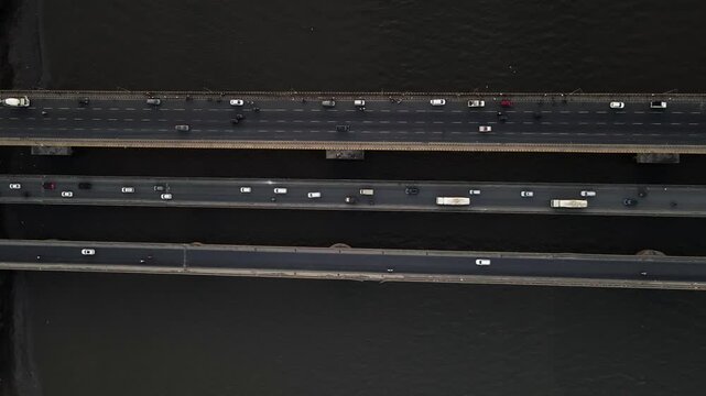 Aerial drone view of the Vasai Creek Bridge in Mumbai, India, spanning across the water and connecting key suburban regions. The scene captures vehicles moving along the bridge.