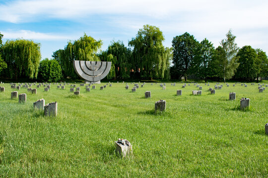 Jewish cemetery with a menorah memorial and grave markers, Terezin, Czech Republic