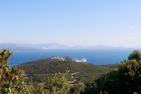 Scenic view of a Greek island and distant lighthouse