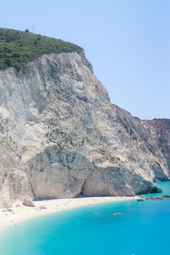 Turquoise water at the base of massive white cliffs