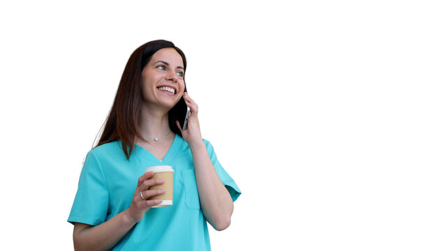 Smiling healthcare worker talking on smartphone drinking coffee