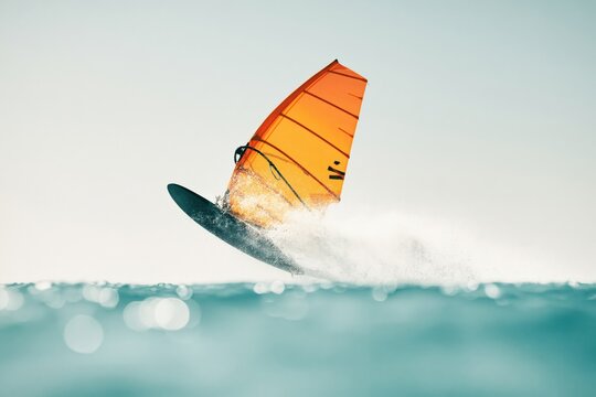 Windsurfer glides over the water in a vibrant display of sport and skill on a sunny day