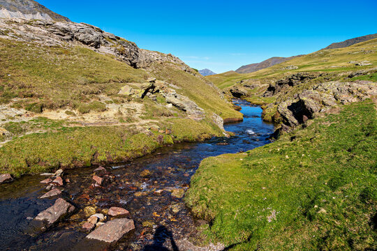 Hiking trail in Cirque de Troumouse at Heas in the Hautes-Pyrenees department in France, forming the border with Spain