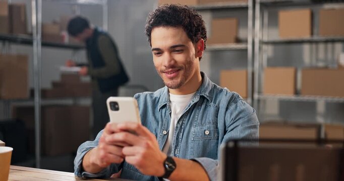 Happy, man and phone in small business for logistics, package dispatch or sales target in shipping. Staff, person or laugh with mobile for good review, delivery confirmation or typing digital receipt
