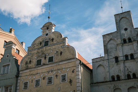 Architectural detail shot of the Three Brothers complex displaying Gothic and Renaissance gables under sunny sky in Riga Old Town, Latvia
