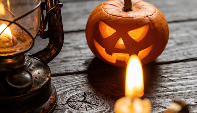Halloween pumpkin jack o lantern glowing with rustic lantern, spooky autumn festival night carved squashes decoration, dark wooden table candle light flame, seasonal eerie horror holiday background.