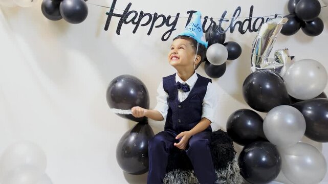 Happy Little Boy Enjoying Birthday Celebration With bubble play and Festive Decorations