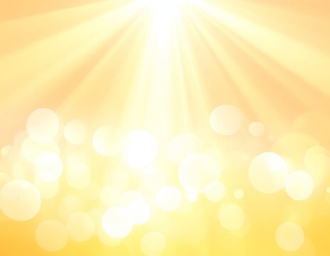 Warm, radiant abstract background with golden light rays and bokeh effect