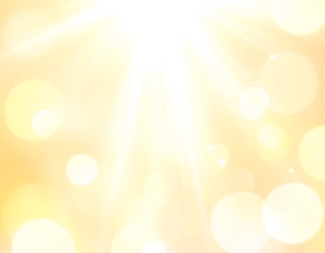 Soft, golden background with bright light rays and glowing bokeh effects