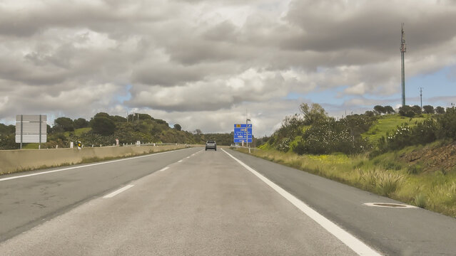 Castro Marim, Portugal, March 14, 2026. Traffic moves along the A49 motorway toward Ayamonte and Huelva with large highway direction signs above the road.
