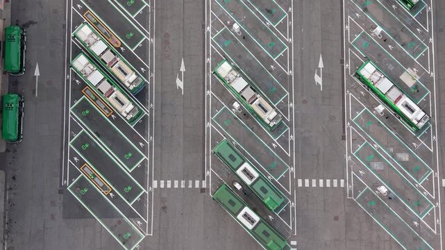Aerial view of electric buses parked at charging stations in San Donato Milanese, Milan, Italy, illustrating modern public transport and clean energy infrastructure.