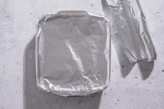 Foil covered baking dish with aluminum roll on side