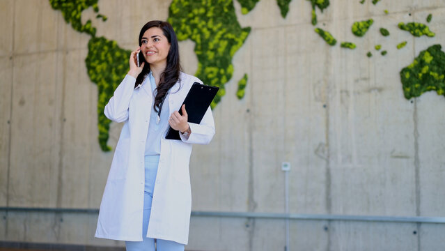 Doctor woman talking on phone with world map