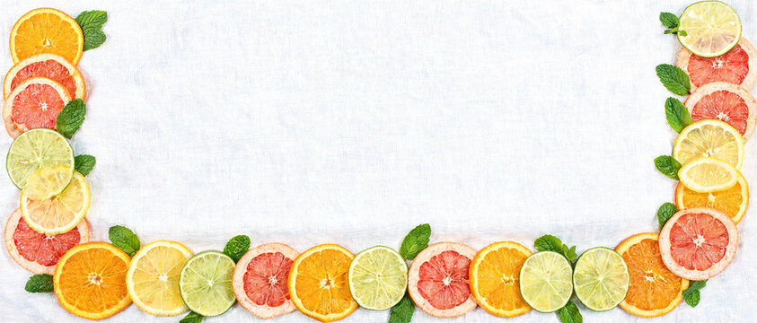 Citrus fruit slice frame banner, Organic orange lemon lime grapefruit layout, Top view flat lay summer background, Tropical ripe vitamin border template, Healthy food copy space backdrop layout.