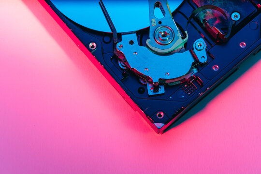 opened computer hard disk drive HDD internal components focusing on plattered disk and actuator read write head arm as a conceptual metaphor for cyber security big data cloud computing infrastructure 