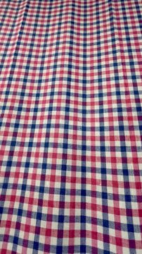 Red, blue, and white gingham checkered fabric texture background