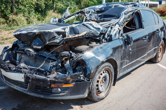 Wrecked car accident with destroyed front, crushed hood, collision damage, insurance and total loss.