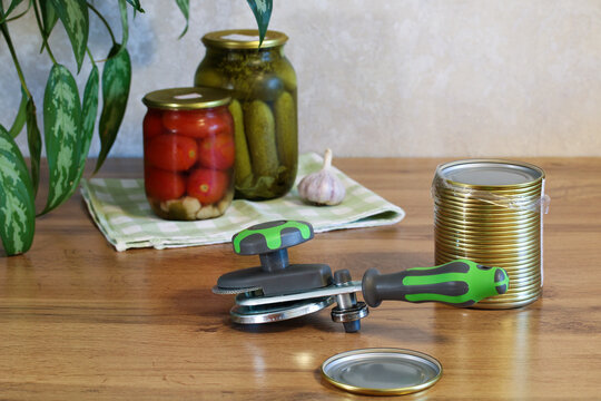 Manual canning sealer for home food preservation with pickled vegetables and jars