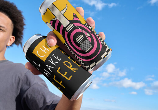 Mockup of black man  under a blue sky holding two plain cans in their hand. The clouds are visible in the background.