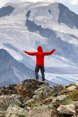 Obraz premium Hiker in Red Jacket Embracing Alpine Scenery, Pennine Alps, Valais, Switzerland