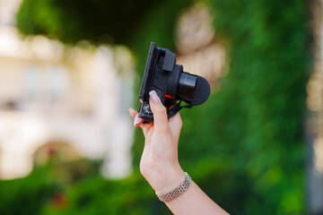 Fototapeta premium Woman Hand Holding Compact Digital Camera Outdoors