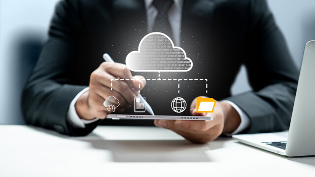 Businessman using a digital tablet with stylus to manage cloud computing and data storage connectivity. Cloud computing network data concept