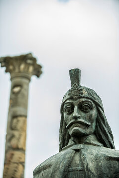 Bronze Statue of Vlad the Impaler with Helmet and Mustache, Column in Blurred Background