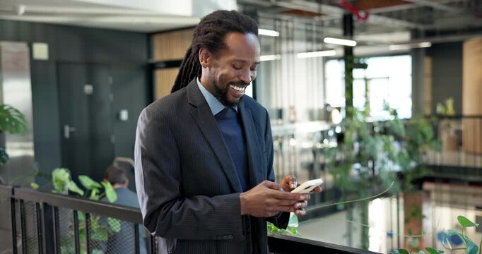 Laugh, texting or black man in office with phone, online communication or comic post on chat app. Happy, digital and employee in agency with tech, funny message and business meme on social media.