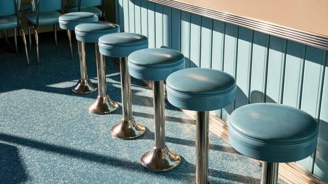 Retro diner stools in a row, bathed in dappled sunlight