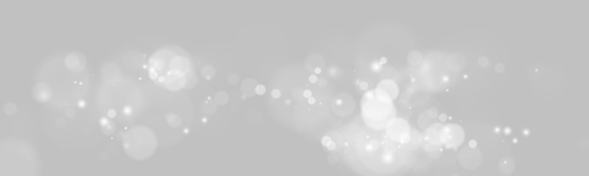 Horizontal trail of soft white glowing bokeh lights with scattered sparkles on transparent background