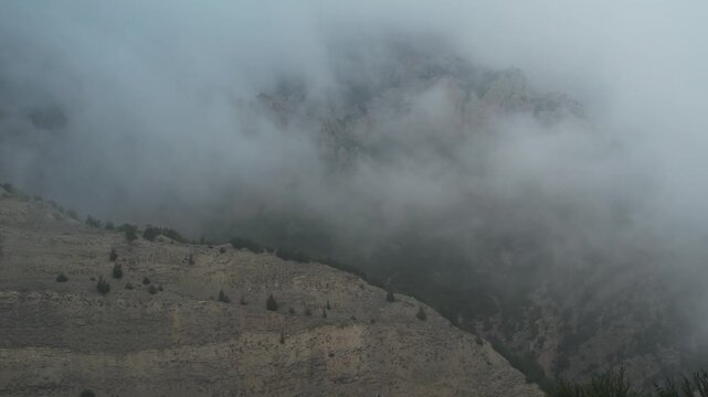 Thick fog blankets the landscape with soft white mist under cloudy sky for weather nature abstract atmosphere landscape drone photography footage high resolution stock media