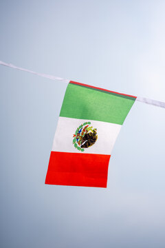 Mexican national flag displayed for Mexico Independence Day, D&iacute;a de la Independencia de M&eacute;xico, celebrated on September 16. Green, white and red tricolor flag representing Mexican national identity, p