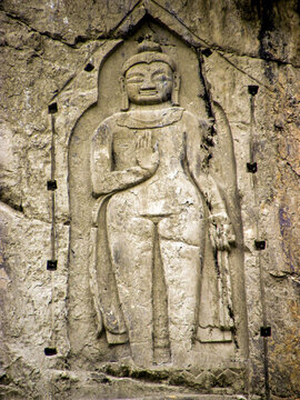View of the ancient Karga Buddha rock carving etched into a cliff face, showcasing intricate stone details and historical significance in Hunza Nagar, Gilgit-Baltistan, Pakistan.