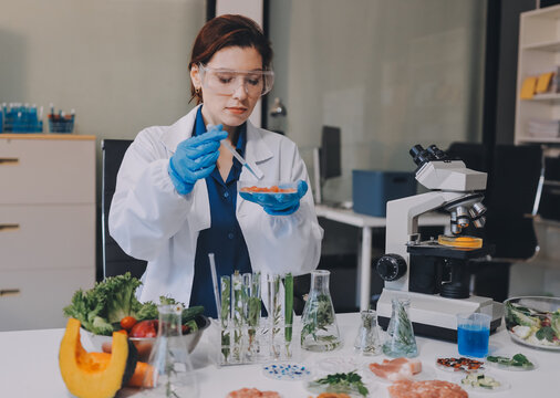 Scientists in lab coats work with plants in a modern lab, focusing on research and experimentation under bright, sterile conditions.