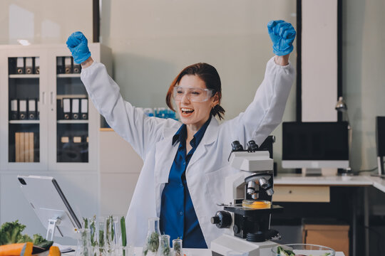 Scientists in lab coats work with plants in a modern lab, focusing on research and experimentation under bright, sterile conditions.