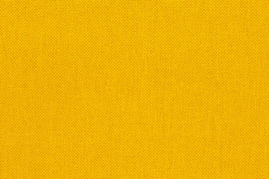Yellow linen fabric cloth texture background, seamless pattern of natural textile.