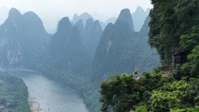 Woman tourist enjoy the beautiful landscape of yangshuo county, China