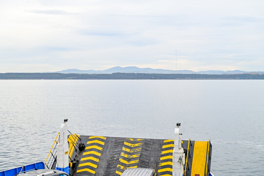 Crossing th Dardanelles Strait by car ferry from Eceabat to Canakkale, with a view of the car deck and the coastline; a boat trip in Canakkale Province, Turkey