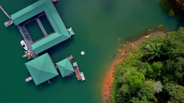 Overhead aerial view of a floating resort water chalet in Kenyir Lake, Terengganu, Malaysia.